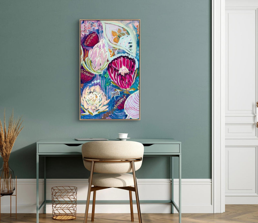 Colorful abstract painting on a wall above a desk with a chair.